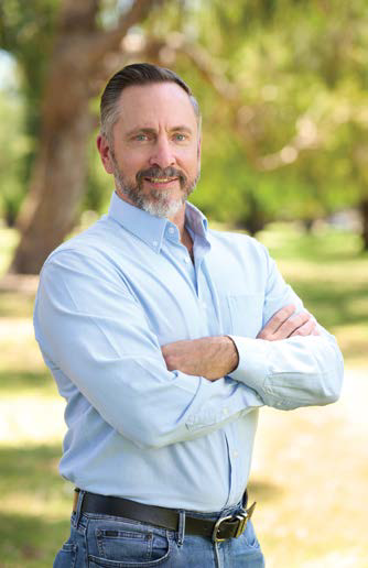Peter Spackman, CEO of vegetablesWA, standing outdoors with arms crossed