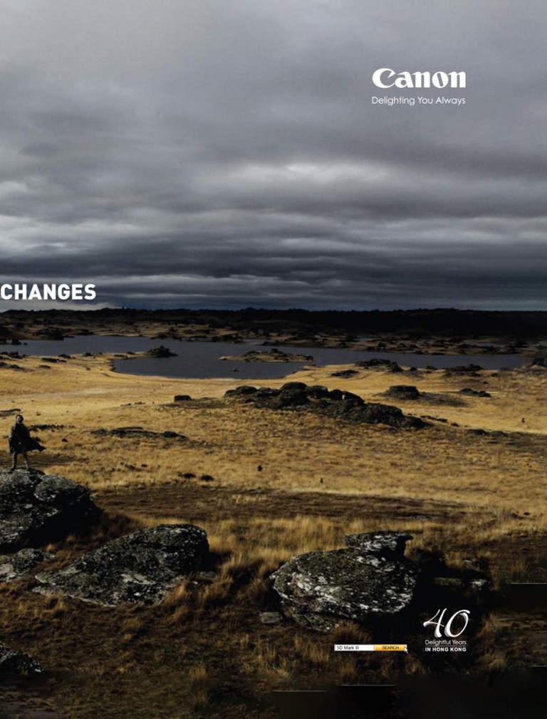 Canon advertisement: a dramatic landscape under stormy skies with a lone figure on rocky terrain, Canon logo and 40 Delightful Years in Hong Kong branding