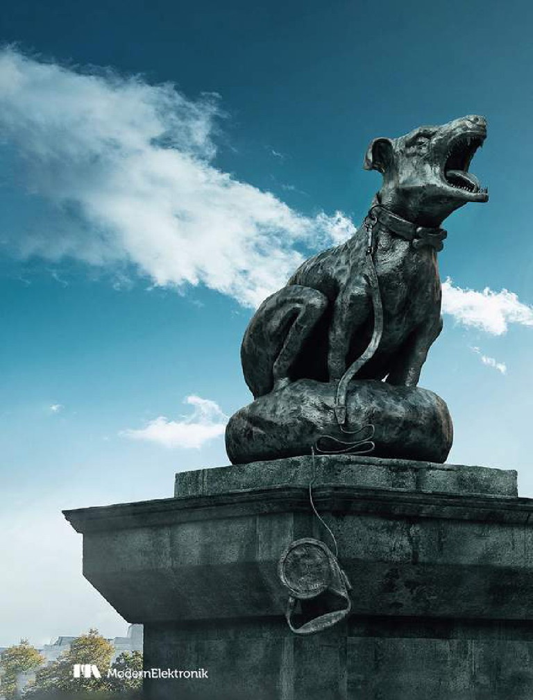 Bronze statue of a howling dog against a blue sky with clouds, with a ModernElektronik logo in the bottom corner