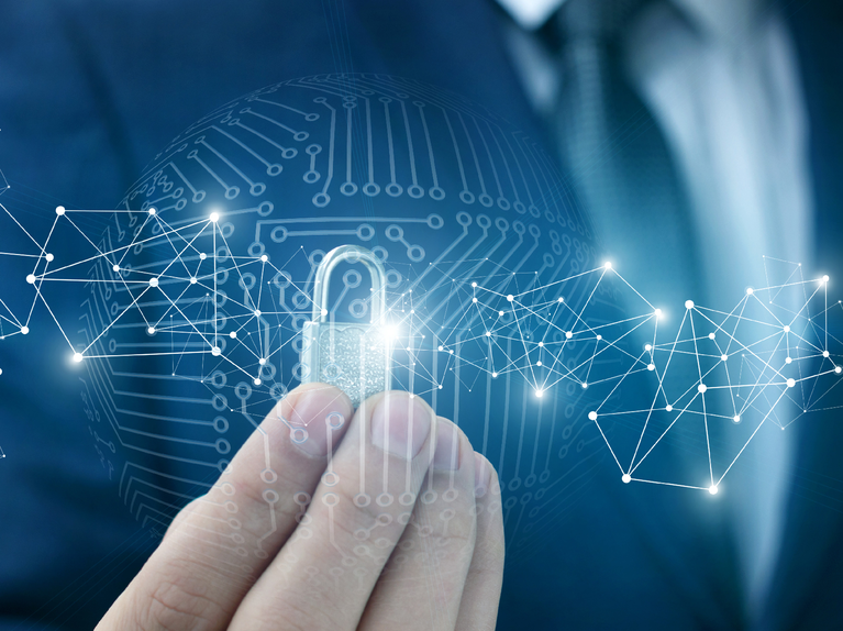 Hand holding a glowing padlock with cyber network background