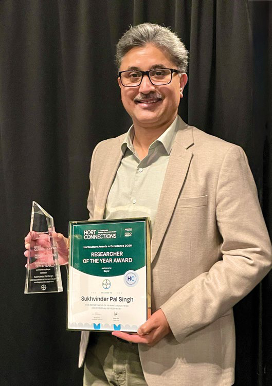 Dr Sukhvinder Pal Singh holding his Researcher of the Year award and certificate
