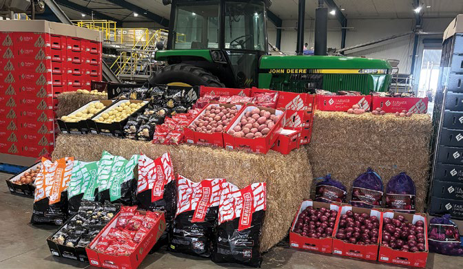 Crates of fresh produce on display with tractor at farm