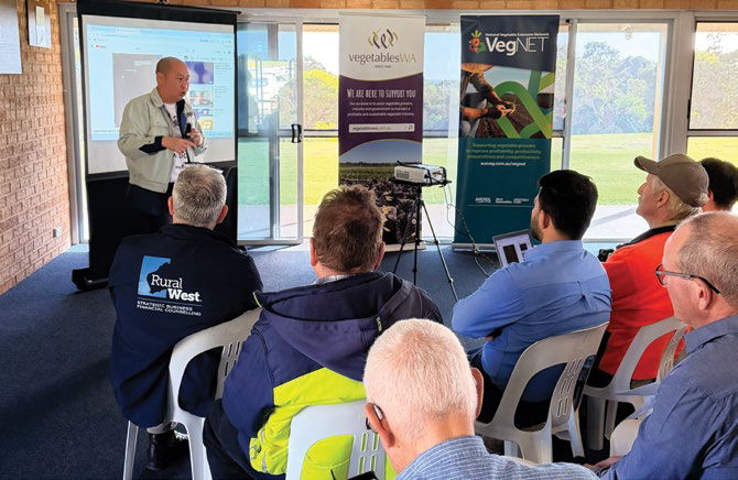 Presenter speaking to a seated audience at the roadshow