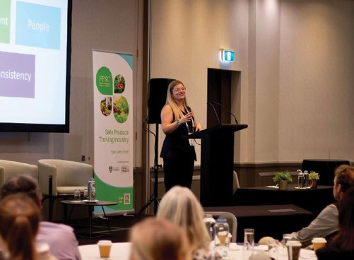 A speaker addressing attendees in a discussion group