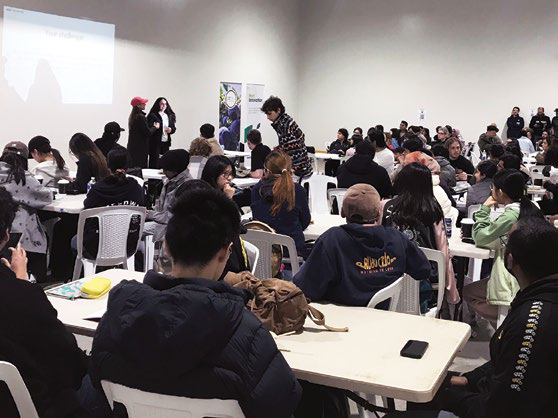 Students seated at desks in a training room for Hack The Harvest