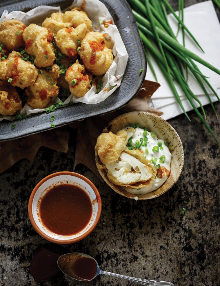 Vegan buffalo cauliflower wings with garlicy ranch dip and hot sauce